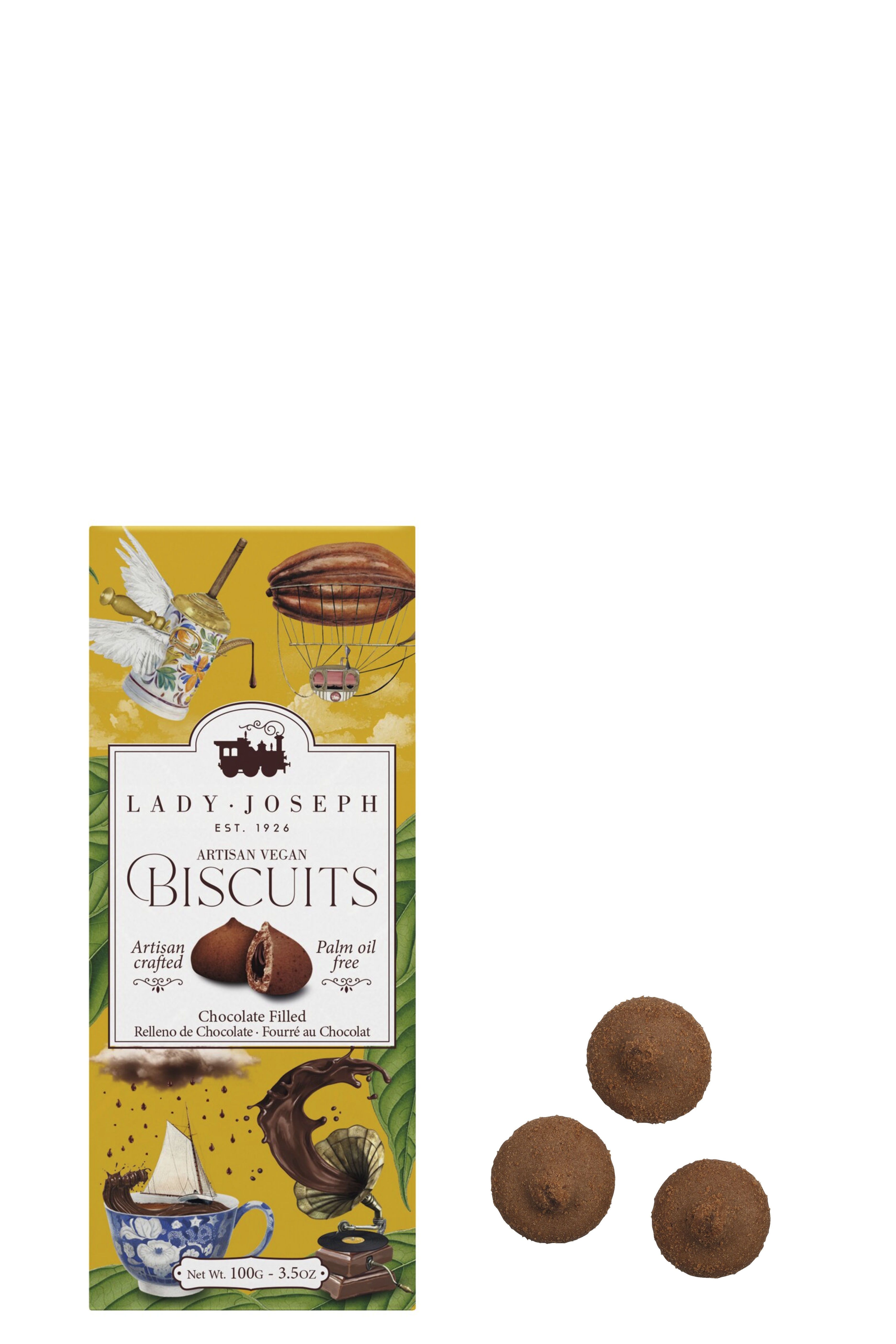 Gelbe Verpackung mit verspielten Illustrationen, vorne der Schriftzug „Lady Joseph – Artisan Vegan Biscuits“. Drei runde, schokoladige Kekse mit Füllung liegen daneben. Nettogewicht: 100 g.