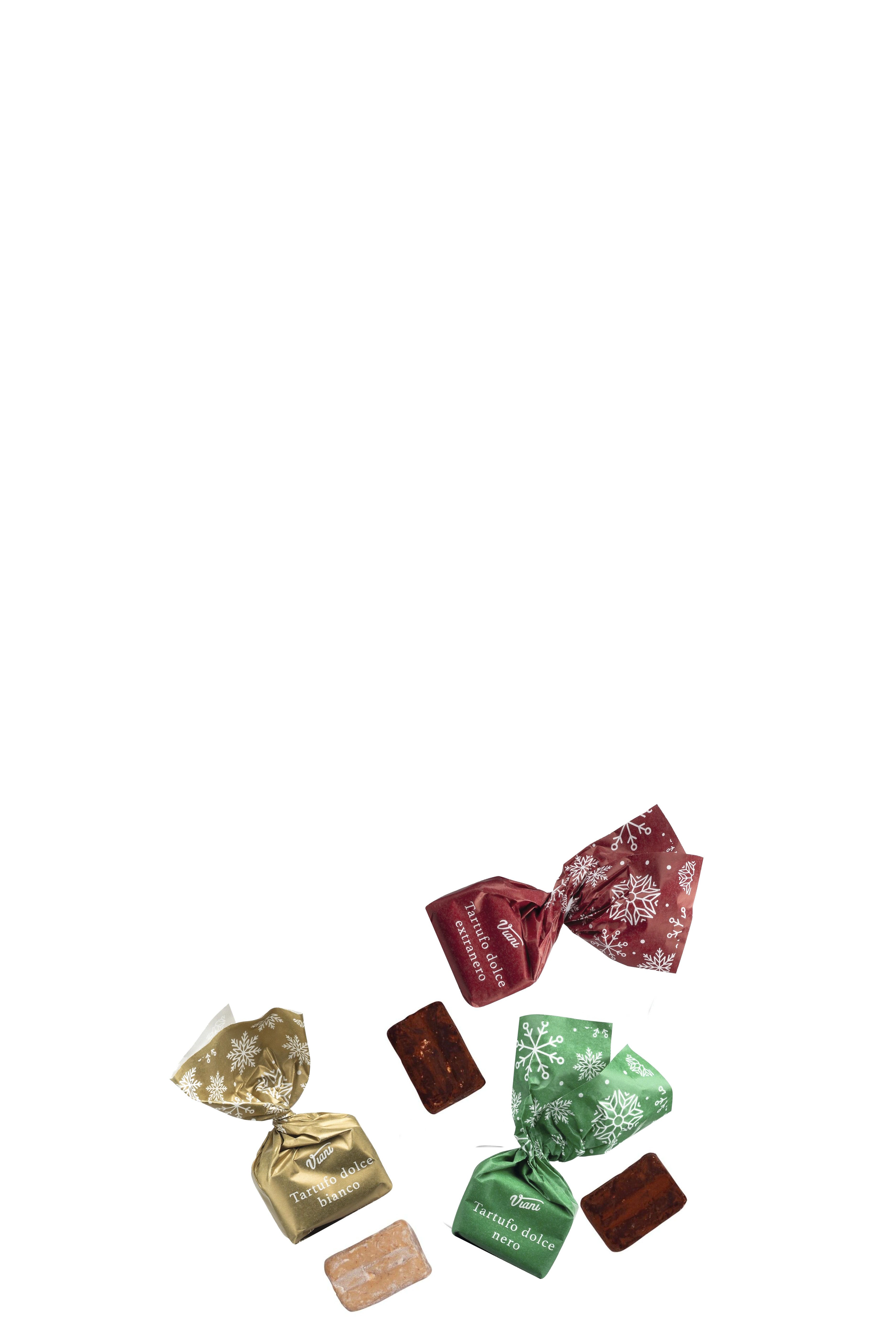 Das Bild zeigt drei einzeln verpackte Pralinen in weihnachtlichem Design: eine goldene mit weißer Schrift, eine grüne und eine rote mit Schneeflockenmotiven. Daneben liegen jeweils die ausgepackten Pralinen mit erkennbaren Nüssen im Anschnitt