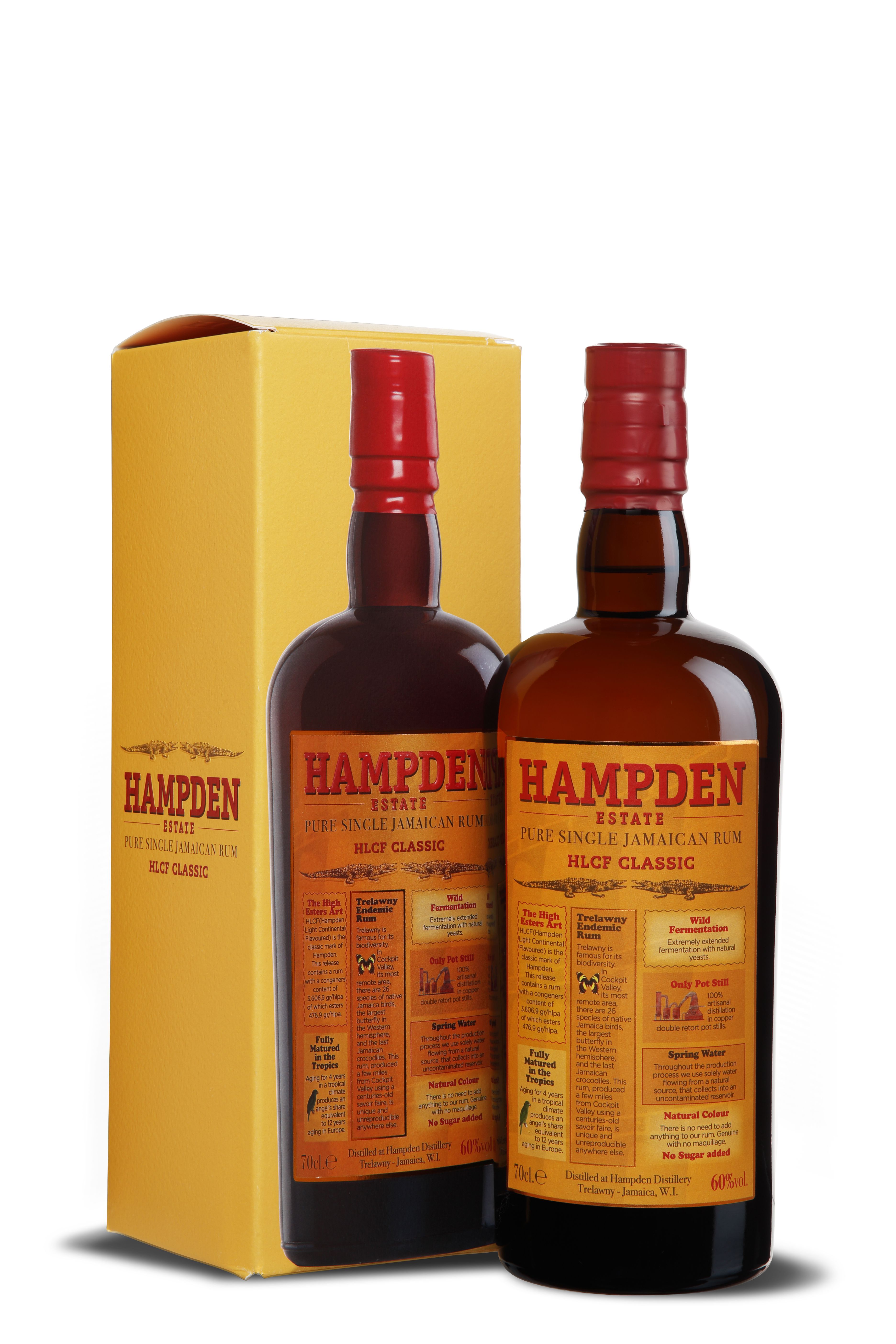 Flasche Hampden Estate HLCF Classic mit dunklem jamaikanischem Rum. Das orangefarbene Etikett zeigt Infos zur Herstellung, 60 % Vol. Alkohol. Steht vor passender gelber Verpackung mit roten Schriftzügen.