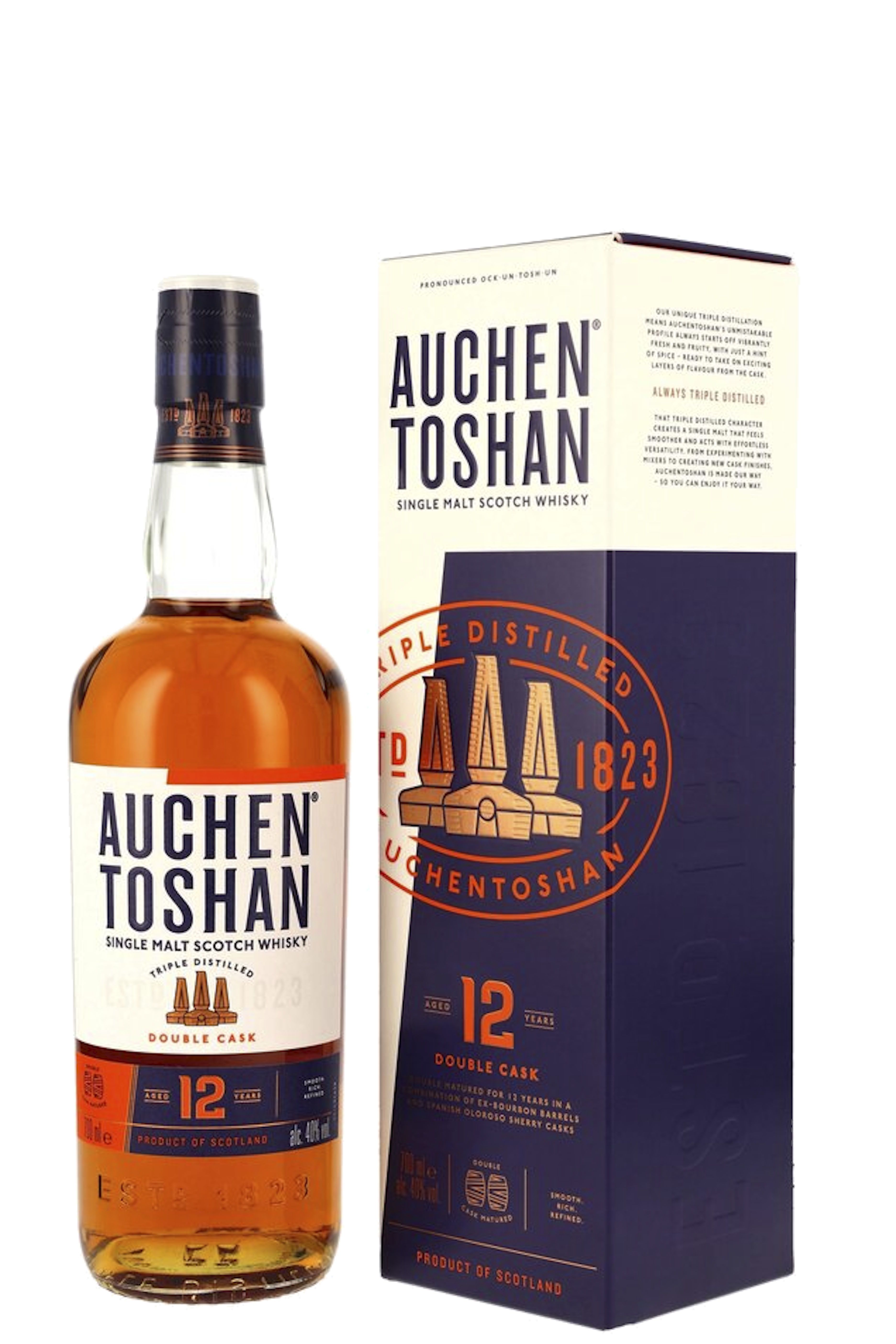 Flasche Auchentoshan 12 Years vor einer schwarzen Geschenkbox mit rotem Farbverlauf und Skyline-Motiv. Das moderne Design wirkt urban und prägnant. Der Whisky schimmert in warmem Goldton, betont durch das leuchtend rote Etikett und klare Linien.